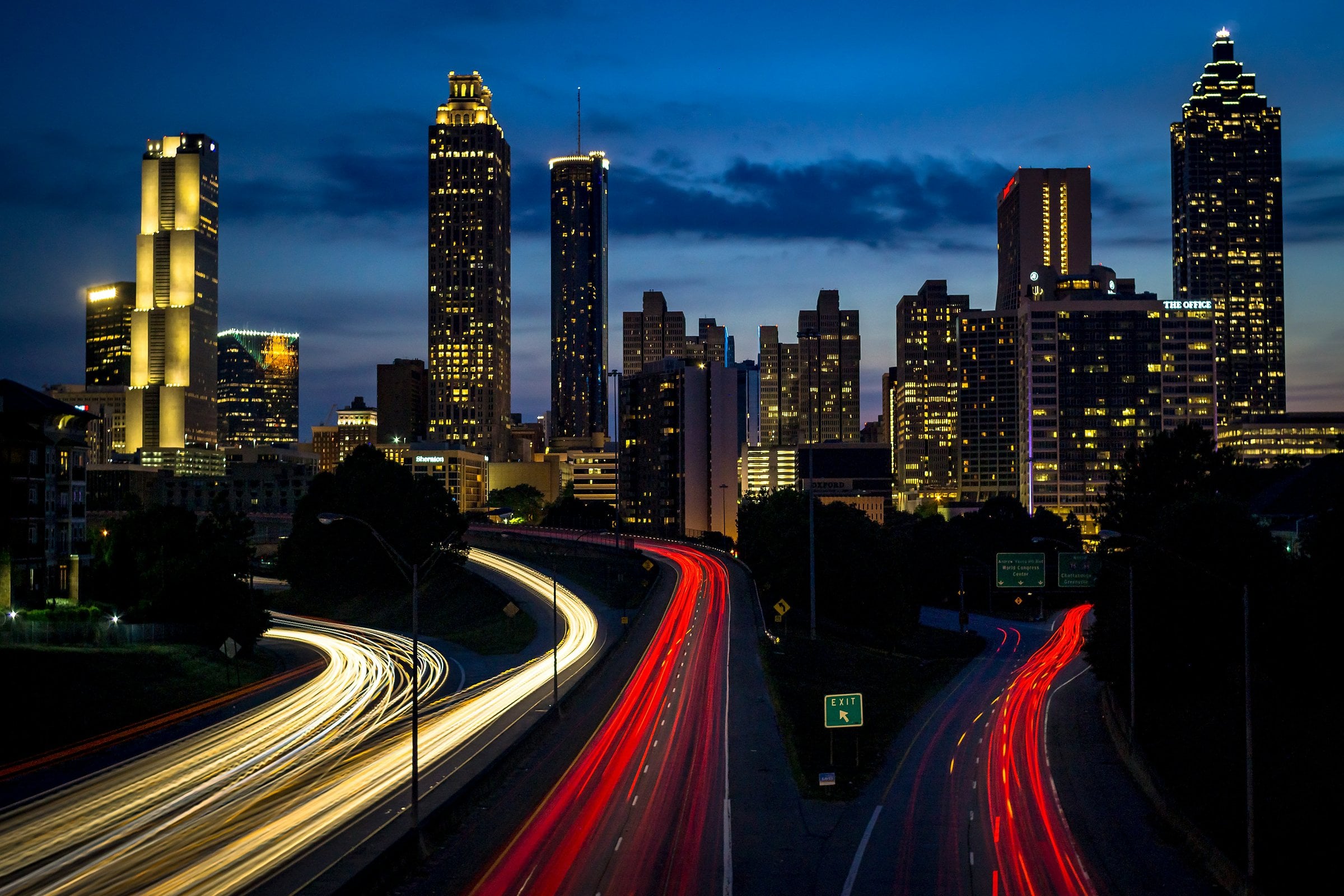 Atlanta skyline at dusk with highway light trails
