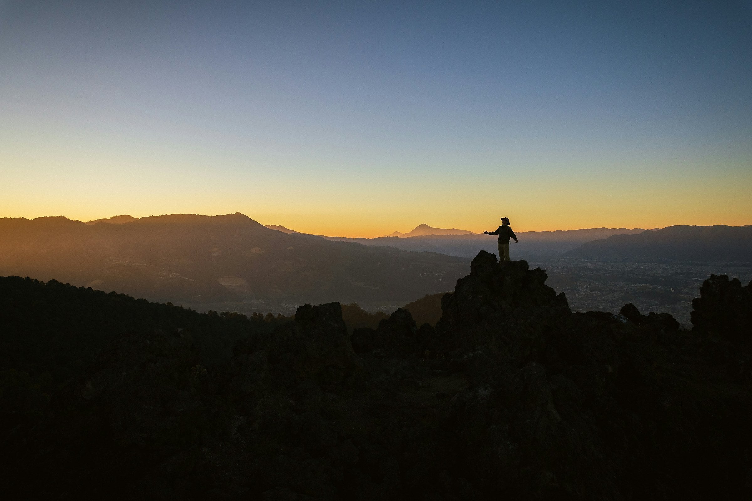 Friends at dawn raising hands together